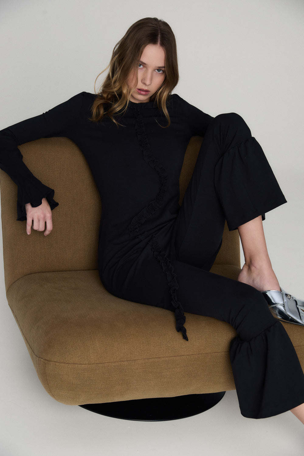 Soft flowing dress with a relaxed oversized silhouette and delicate ruffle detailing, photographed against a clean neutral background