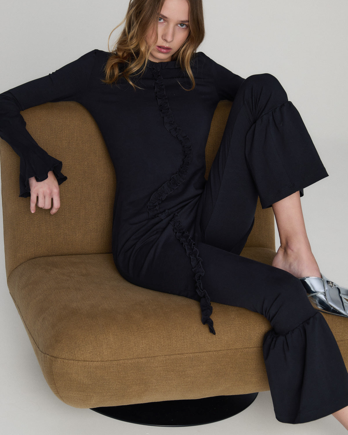 A soft, flowing midi dress with delicate ruffle details and an airy oversized silhouette, photographed against a clean neutral background.